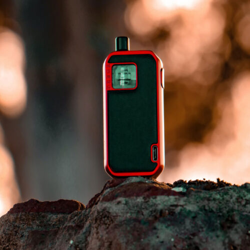 Red and Black Vape Standing on a Rock